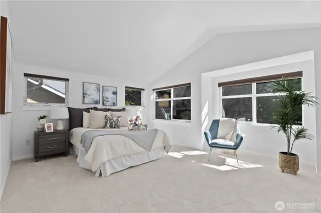 Uppder floor Primary with vaulted ceiling and big windows.