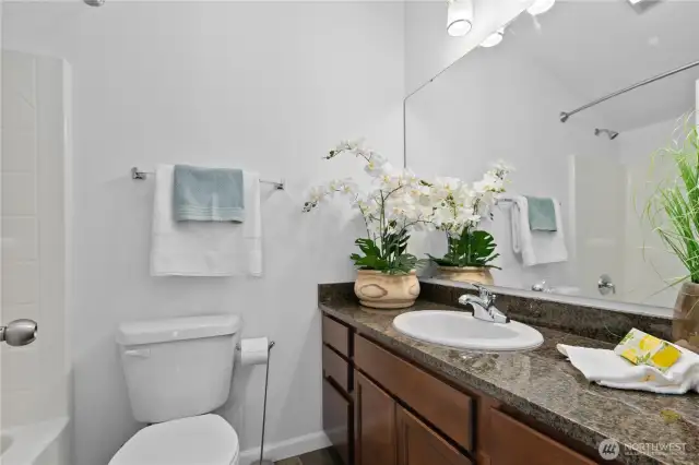 Upper floor 2nd primary full bathroom and granite countertops.