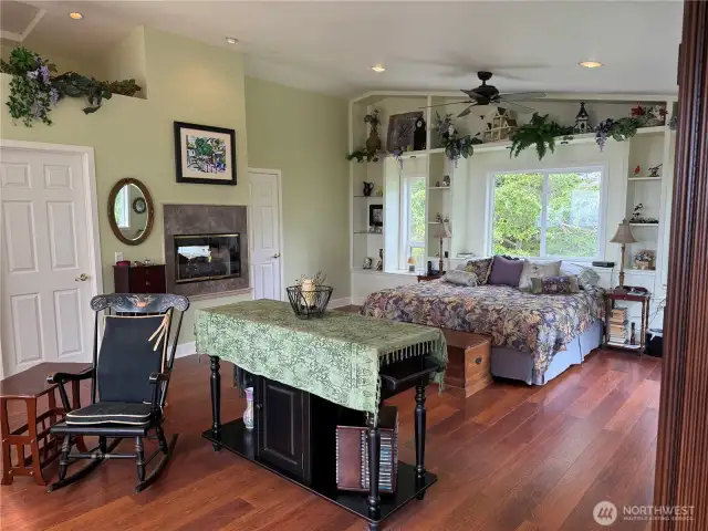 Primary Suite with propane fireplace seen from both bedroom and bath. Ocean view in bed or otherwise. Forest views as well. Ceiling fan.