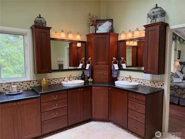 Stained cherry cabinets with two sinks and turn table in center cabinet.