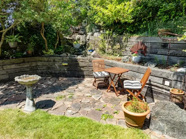 On the northwest is a patio and waterfall. Terrance landscaping.