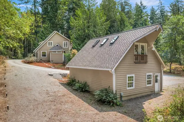 The capacious, detached, 2-car garage has plenty of storage for all of your gear plus your cars! Enough parking space for your RV, boat and travel trailer. Notice the juliette balcony in the garage loft.
