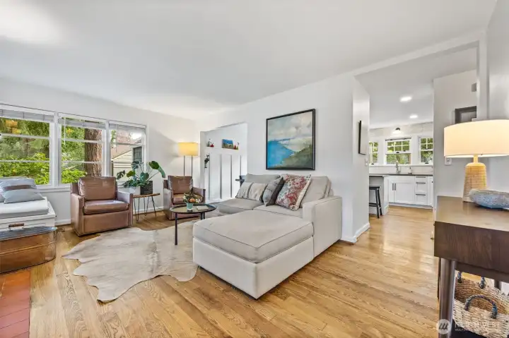 A warm and thoughtful living space with tons of natural light and gorgeous hardwood flooring.