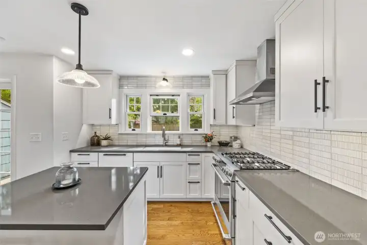 Stunning kitchen renovation with custom cabinetry by Acorn Cabinets and classic Ann Stacks tile backsplash.