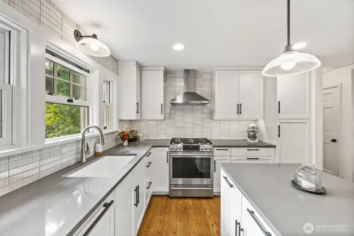 Luxurious finishes throughout this stylish kitchen remodel including Restoration Hardware lighting and cabinet pulls.