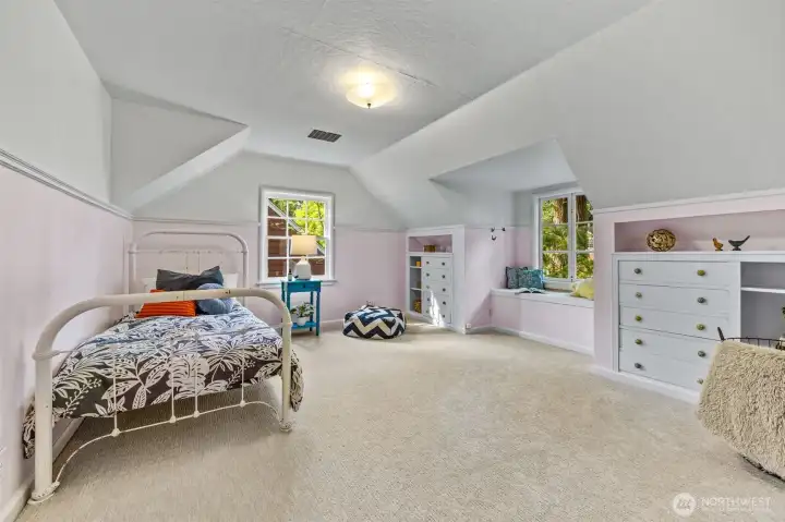 First of two large, upper floor bedrooms with delightful, built-ins and custom dormer bench.