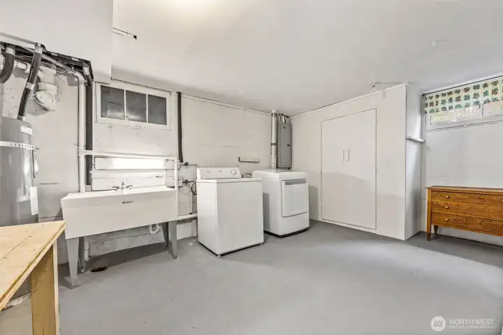 Very clean and spacious laundry room offers classic laundry shoot!