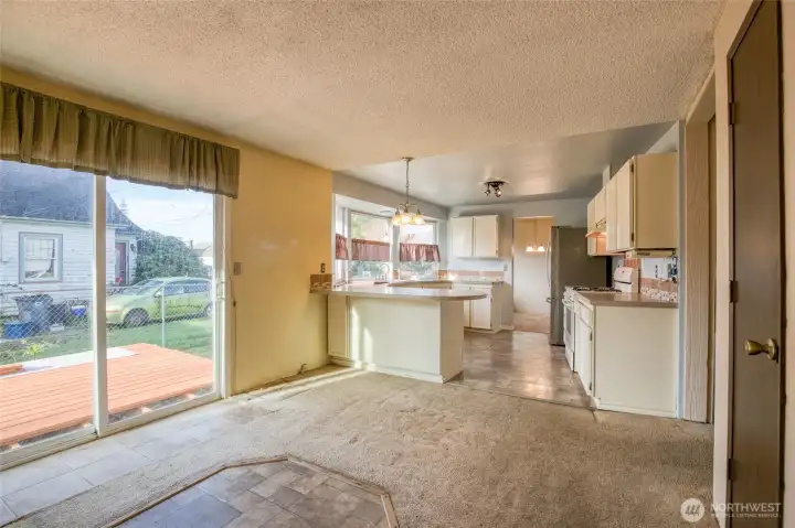 Eating space in the kitchen with sliding glass doors to the back deck