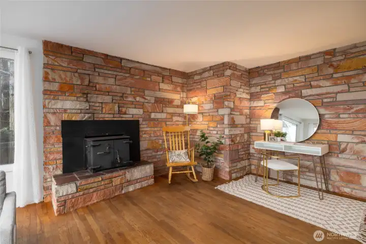 Beautiful sitting area with wood burning insert. Stunning mid-century style masonry. (staged)
