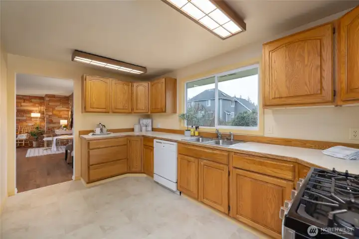 Another view of the kitchen with wood cabinetry.