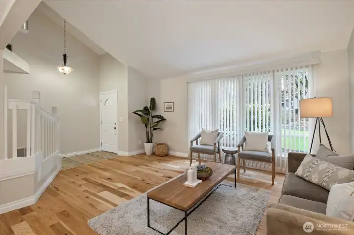 View of living room and entryway from dining area.