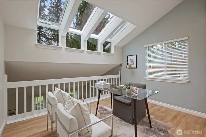Open, second-level loft w/venting four pane sky wall windows that open to capture that morning light and afternoon breezes.