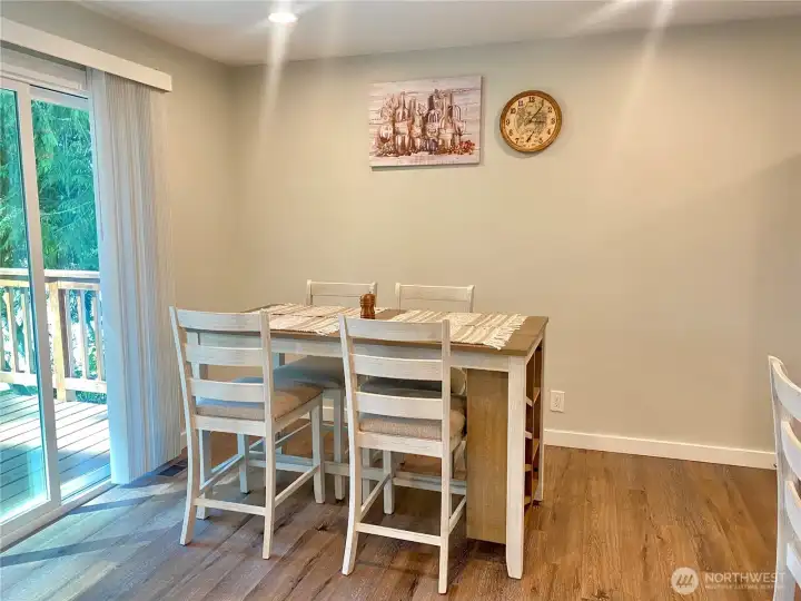 Dining room next to glass sliding door to patio