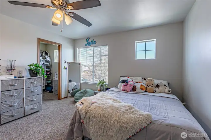 Secondary bedroom with a walkin closet