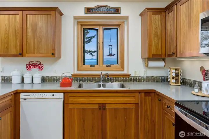 Cherry cabinets in the kitchen.  Look closely at the hummingbird on the feeder in the window.