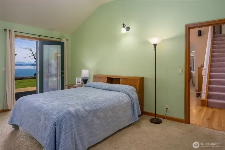 Primary bedroom with French doors to the deck.