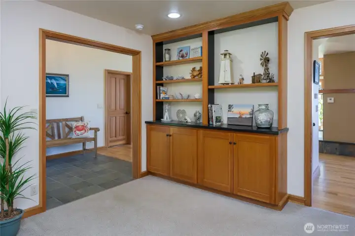 The den/office has a built-in bookcase and is between the entry and eating area.