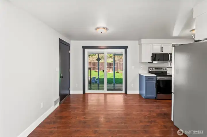 View from living room towards front door and kitchen