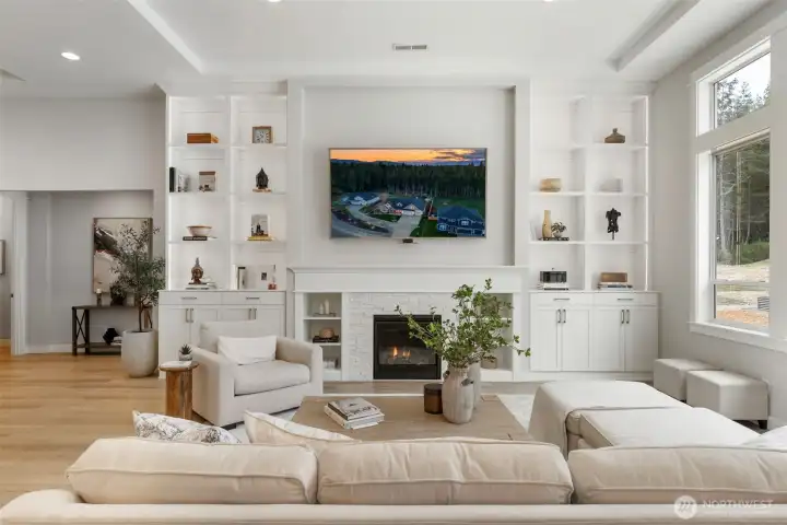 Picture slow evenings here, the fire on, custom built-ins softly illuminated with picture lighting, and a space that feels curated yet comfortable, perfect for unwinding or gathering with ease.