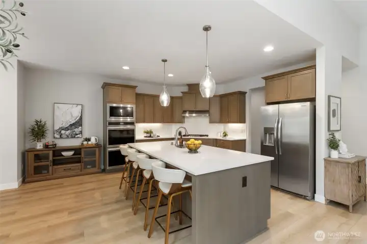 This is where everyone naturally gathers, the oversized island, warm lighting, and open flow creating a space that makes hosting feel effortless and everyday moments feel a little more special.