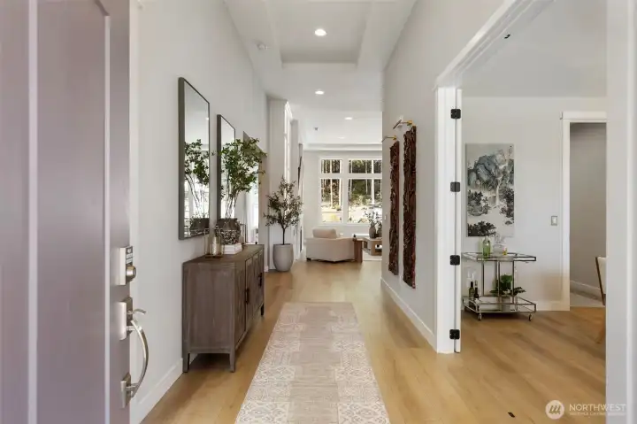Step inside to a sense of openness and ease, soaring 12’ ceilings and luxurious LVP flooring create a bright, refined entry that sets the tone for the entire home.