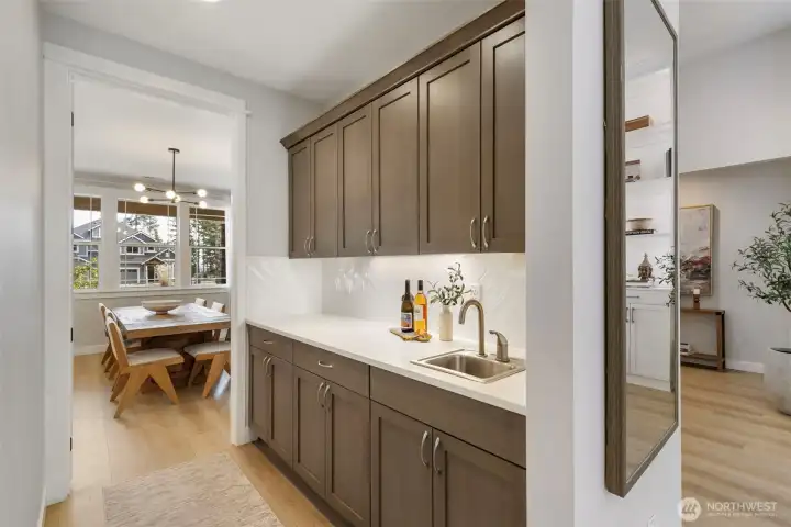 Entertain effortlessly with a dedicated butler’s pantry, complete with a bar sink and ample prep space—keeping everything organized, tucked away, and ready for gatherings of any size.