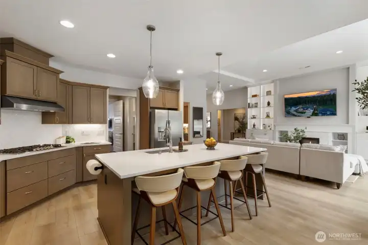 Gather around the oversized island, perfect for casual mornings, evening conversations, or hosting with ease—seamlessly connected to the heart of the home.