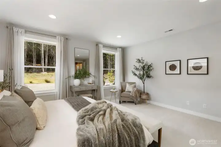 Wake to peaceful, tree-lined views and unwind in a spacious primary retreat designed for comfort, quiet, and a true sense of escape.