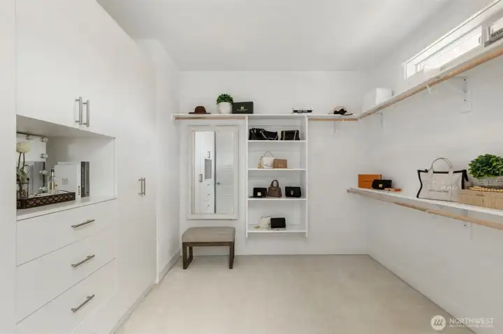 Enjoy a spacious walk-in closet with custom wardrobes and a picture window, bringing in natural light while keeping your daily routine beautifully organized.