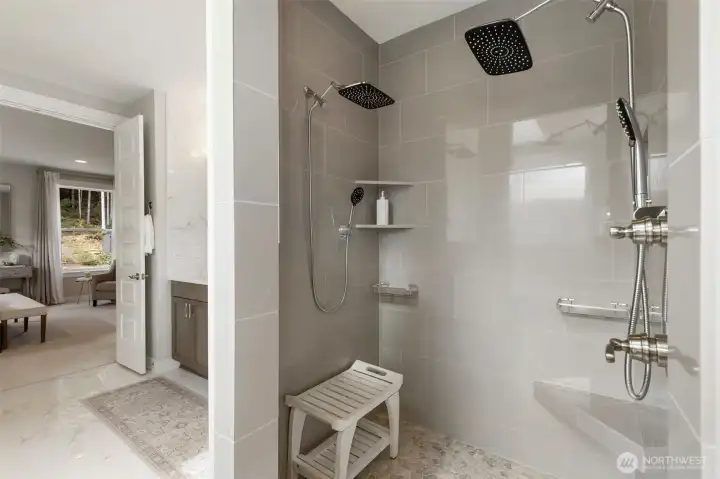 Step into a spa-inspired, curbless shower featuring dual shower heads and built-in shelving, designed for a seamless, luxurious experience every day.