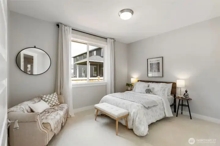 A light-filled secondary bedroom offering comfort and flexibility, perfect for guests, hobbies, or a peaceful personal retreat.