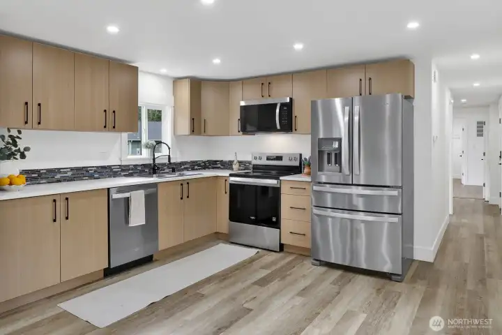 Completely updated kitchen with modern cabinets, new appliances, new sink, and attractive laminate flooring throughout. Completely updated kitchen with modern cabinets, new appliances, new sink, and attractive laminate flooring throughout.