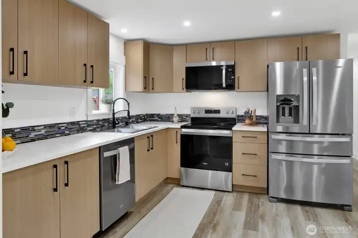The heart of the home, this fully remodeled kitchen invites gathering and connection with new appliances, stylish cabinetry, a new sink, easy-care flooring, and a bright, welcoming feel perfect for everyday living and entertaining. The heart of the home, this fully remodeled kitchen invites gathering and connection with new appliances, stylish cabinetry, a new sink, easy-care flooring, and a bright, welcoming feel perfect for everyday living and entertaining.