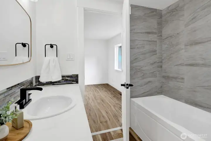 Start and end your day in this fully remodeled en-suite bathroom, featuring a new tub, updated vanity and sink, abundant cabinetry, and a fresh, spa-like atmosphere. Start and end your day in this fully remodeled en-suite bathroom, featuring a new tub, updated vanity and sink, abundant cabinetry, and a fresh, spa-like atmosphere.