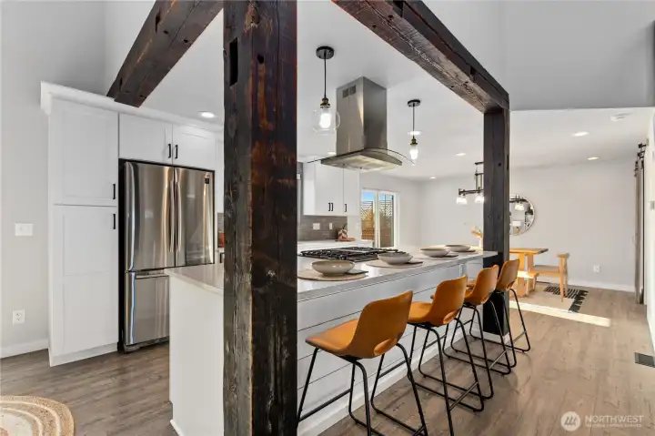 Expansive kitchen features quartz counters, abundant cabinetry, stainless appliances, and oversized island seating. Expansive kitchen features quartz counters, abundant cabinetry, stainless appliances, and oversized island seating.