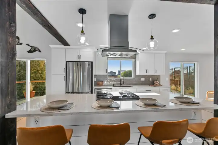 Large central island creates the perfect gathering space for meals, homework, and casual entertaining. Large central island creates the perfect gathering space for meals, homework, and casual entertaining.