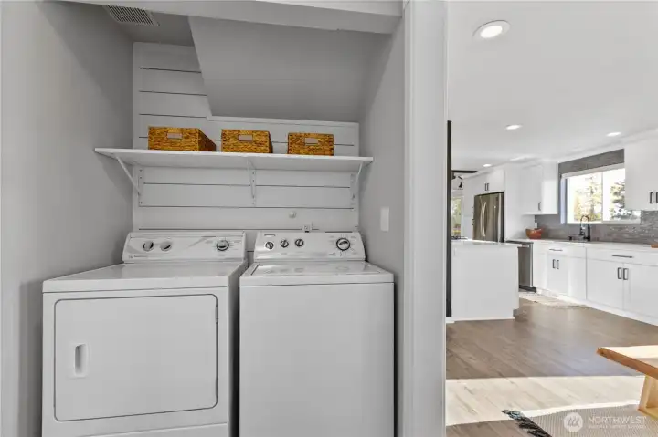 Functional laundry area includes convenient shelving and easy access to the main living spaces for everyday efficiency. Functional laundry area includes convenient shelving and easy access to the main living spaces for everyday efficiency.