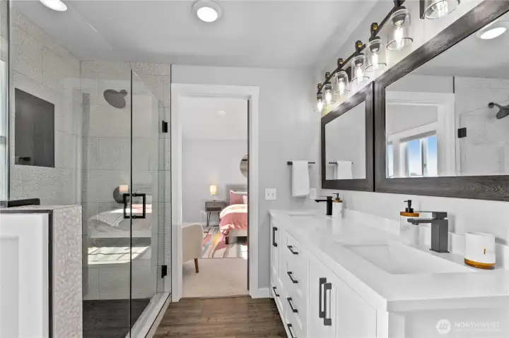 Spa-inspired primary bath featuring a walk-in tiled shower with frameless glass, designer patterned tile, matte black fixtures, and dual vanity setup. Spa-inspired primary bath featuring a walk-in tiled shower with frameless glass, designer patterned tile, matte black fixtures, and dual vanity setup.