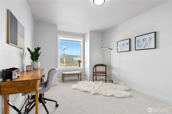 Flexible upper-level room with soft natural light and water views, ideal for a home office, guest space, reading room, or creative studio. Flexible upper-level room with soft natural light and water views, ideal for a home office, guest space, reading room, or creative studio.