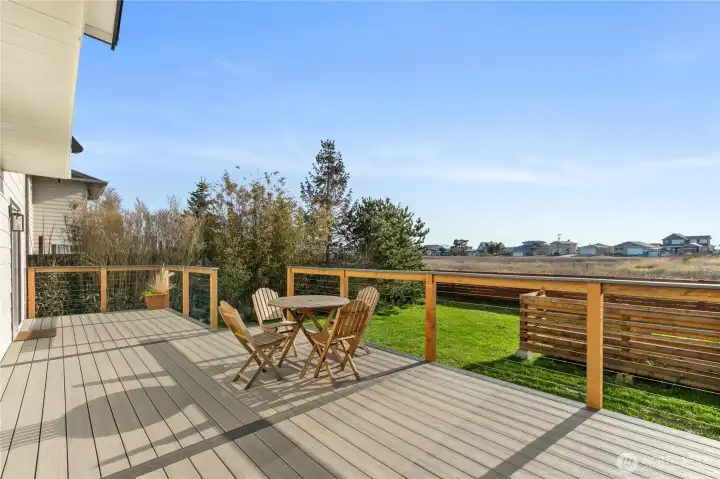 Composite decking and cable railing create a modern outdoor entertaining space. Composite decking and cable railing create a modern outdoor entertaining space.