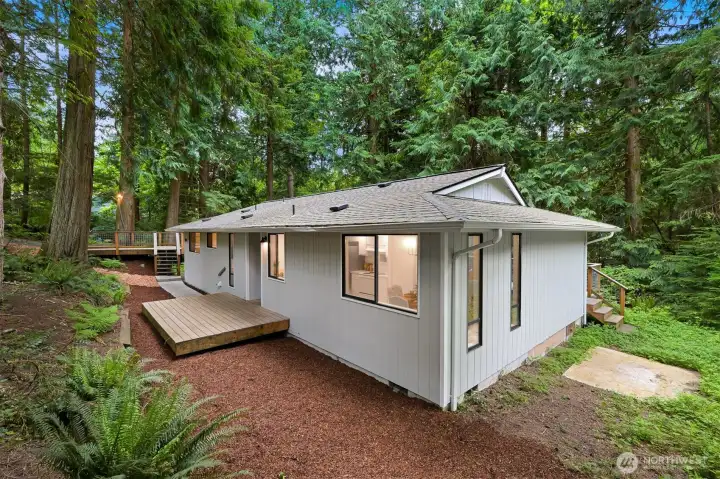 Welcome home! Surrounded by towering trees, this home offers a quiet setting with a strong connection to nature.