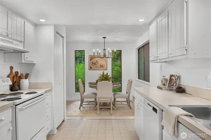 Dining area framed by forest views creates a calming backdrop for everyday meals.