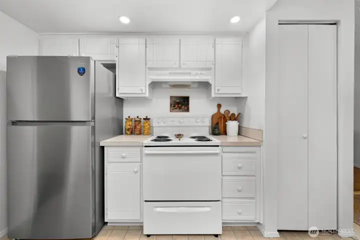 Functional kitchen layout includes abundant cabinetry.