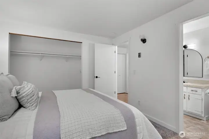 Spacious primary suite includes direct access to the ensuite bath and functional closet space.