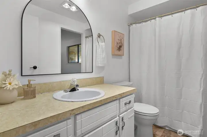 Full bath features a practical layout with updated lighting and everyday functionality.