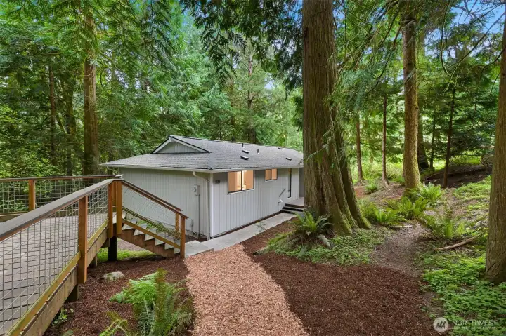 Generous outdoor deck provides either parking or additional living space for dining, entertaining, or enjoying the peaceful surroundings.