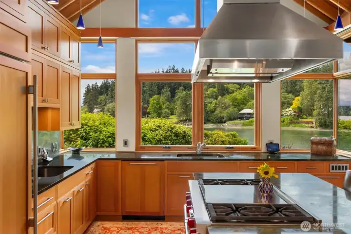 The pitched kitchen ceiling with transoms, VGF framed windows. WOLF dual fuel range with griddle and two ovens. The home and guest studio enjoy high efficiency heating and cooling.