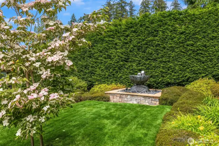Curated gardens with meandering pathways invite meditation and calm. The home is served by public water. All of the gardens are watered from a registered irrigation well that pumps 15 gallons per minute. The property is served by a 26 zone sprinkler system.