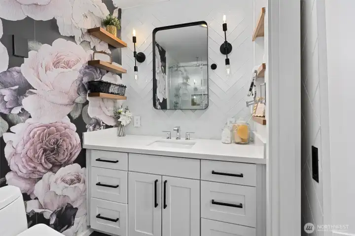 Spa like bath with herringbone tile and designer wallpaper