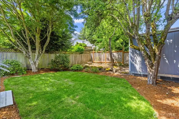 Beautiful and spacious backyard features a large storage shed and even a firepit in the back corner!